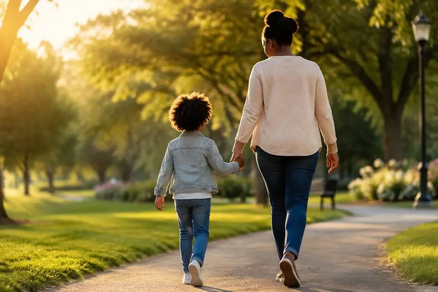 A parent and child walking together in a park